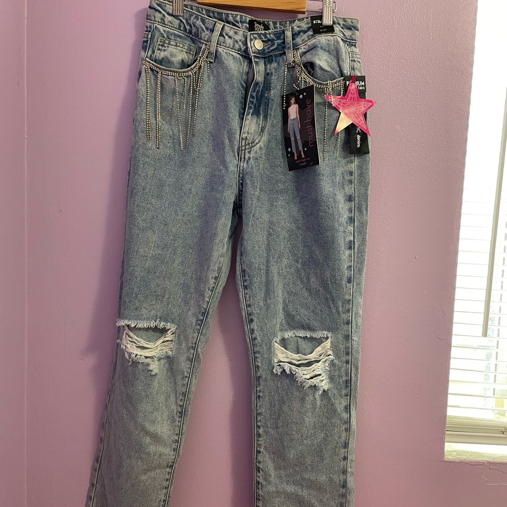 Light wash ripped jeans with tassels